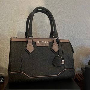 A beautifully designed GUESS women`s purse handbag with light brown logo print